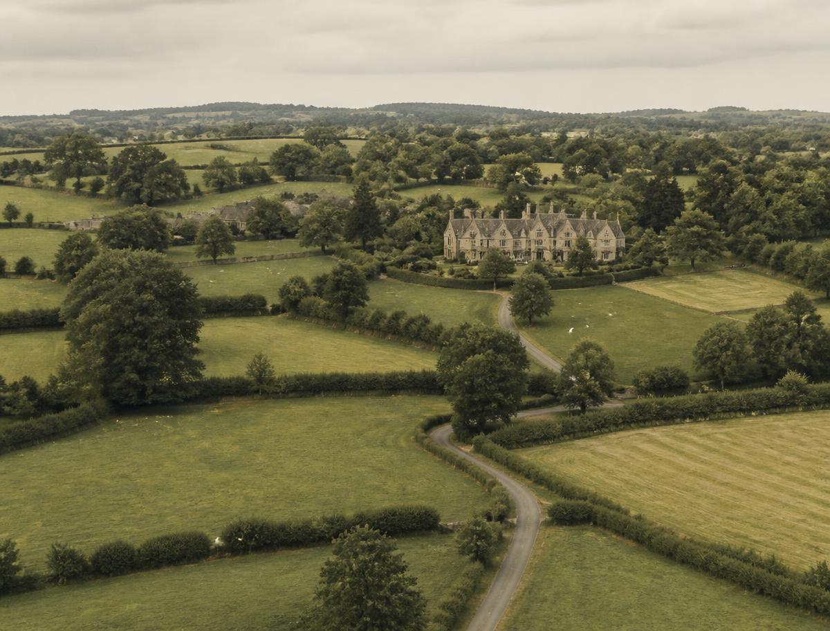 Aerial view of Ashford House among hedgerows and fields in the Cotswolds